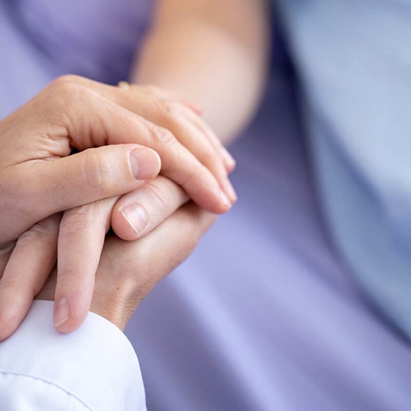 hospice and palliative patient holding hands