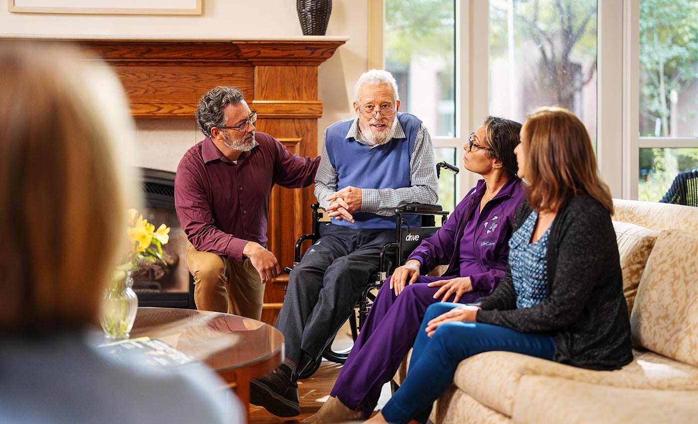 a hospice nursing helping a patient at Transitions LifeCare
